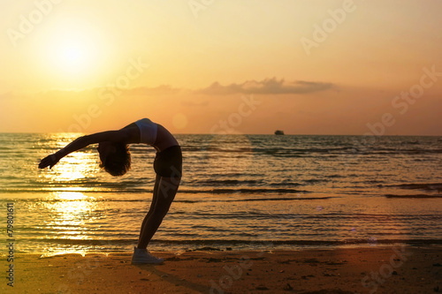 Beautiful sport woman silhouette on the beach