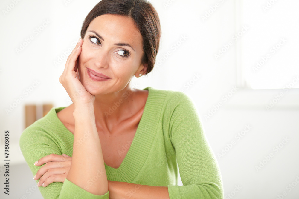Friendly latin lady smiling and looking satisfied Friendly latin lady smiling and looking satisfied