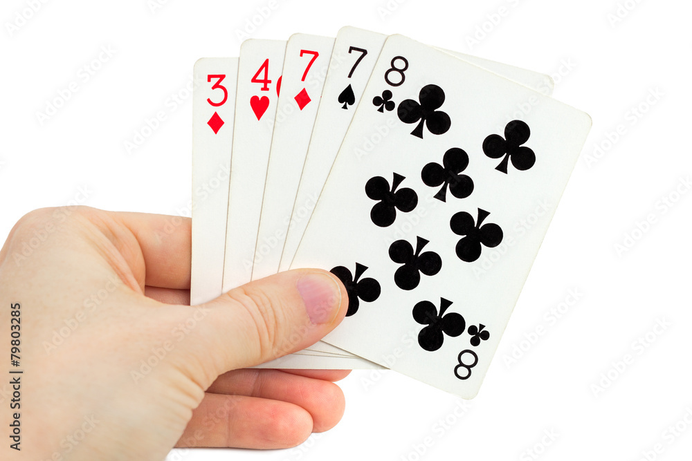 Fototapeta premium Man's hand holding playing cards (one pair), isolated on white