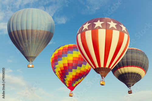 Hot air balloons flying over blue sky photo