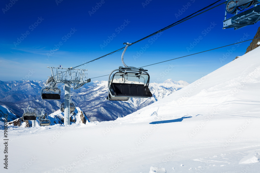 Ski chairlift over mountains on winter resort Ski chairlift over mountains on winter resort