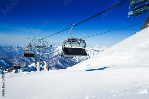 Ski chairlift over mountains on winter resort