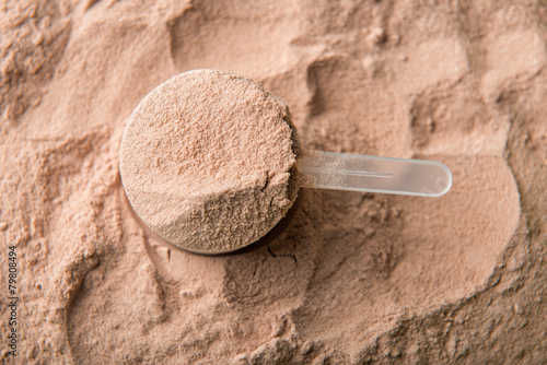 A scoop of chocolate whey isolate protein. photo