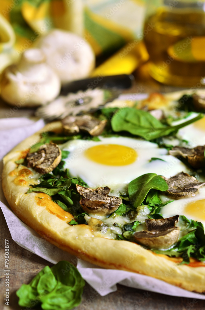 Pizza with spinach,mushrooms and fried eggs.