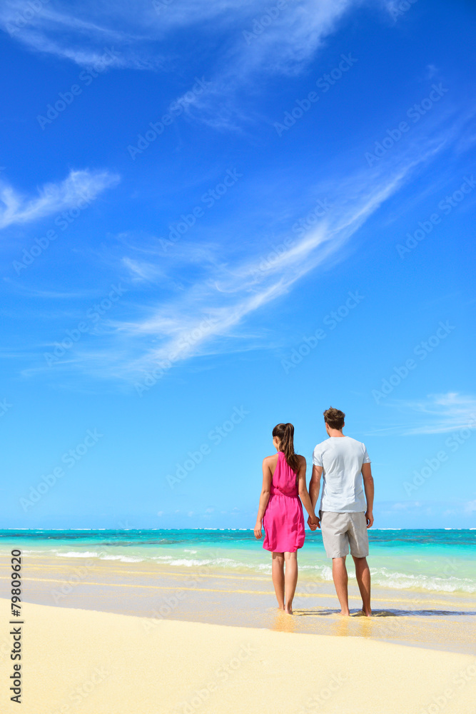 Beach vacation couple relaxing on summer holidays