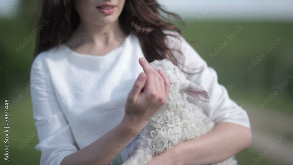 girl holds on hands lamb