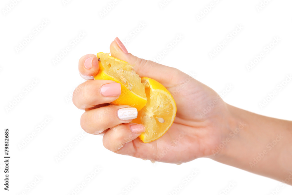 Female hand squeezing lemon isolated on white Female hand squeezing lemon isolated on white