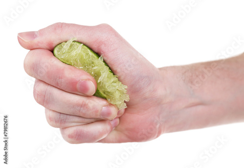 Female hand squeezing lime isolated on white