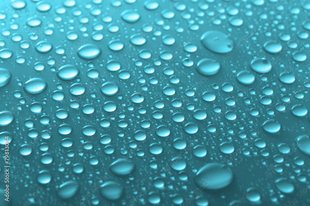 Water drops on glass on light background