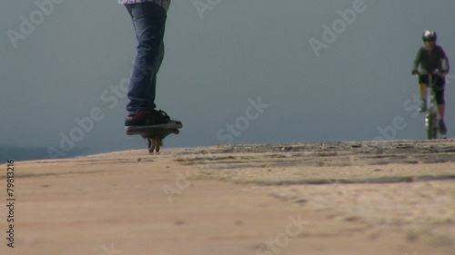 Kid riding caster board on sunny day photo