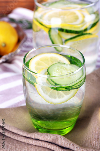 Fresh water with lemon and cucumber in glassware