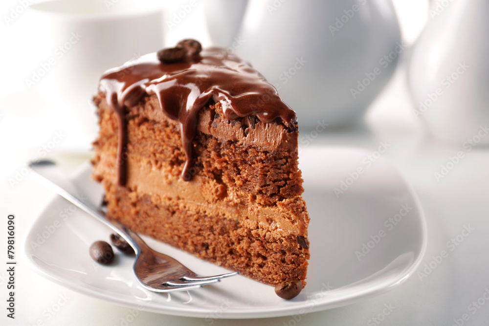 Delicious chocolate cake on plate on table on light background Delicious chocolate cake on plate on table on light background
