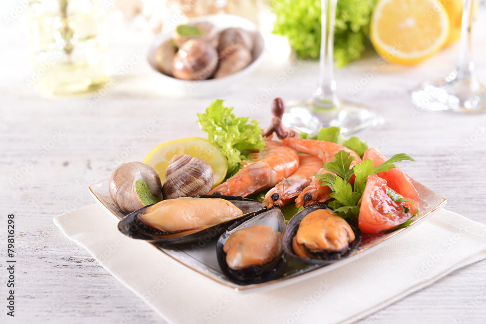 Tasty seafood on plate on table close-up Tasty seafood on plate on table close-up