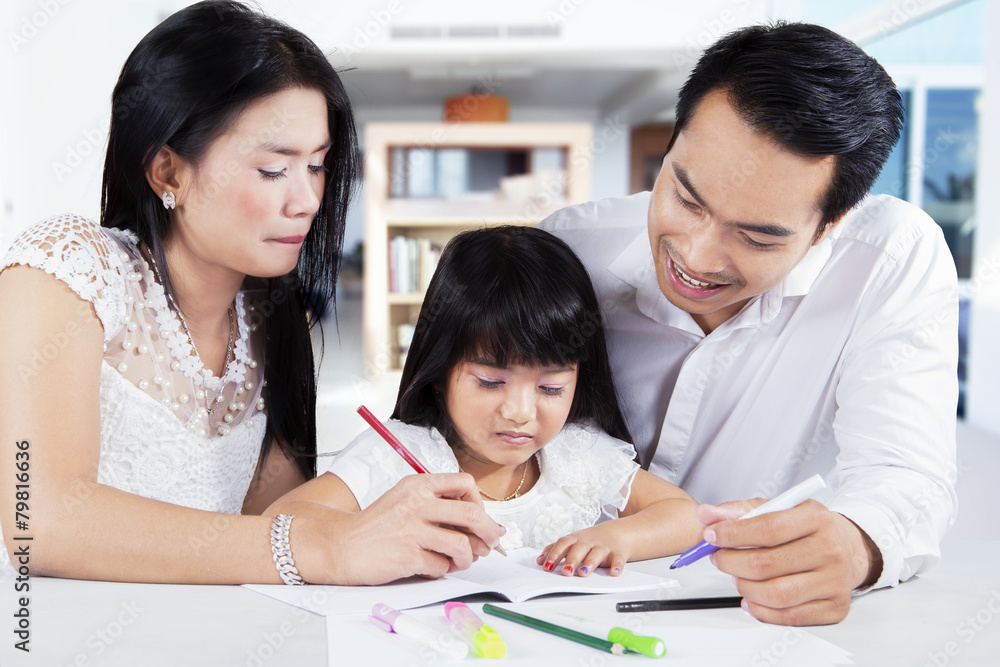 Girl learn to write with parents Girl learn to write with parents