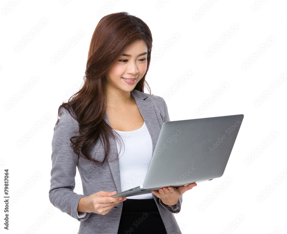 Young asian businesswoman look at notebook computer Young asian businesswoman look at notebook computer