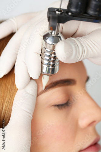 Cosmetologist making perman...