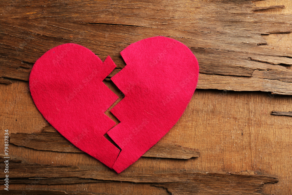 Broken heart on wooden background Broken heart on wooden background