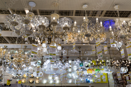 Many beautiful chandeliers light  store © olgavolodina