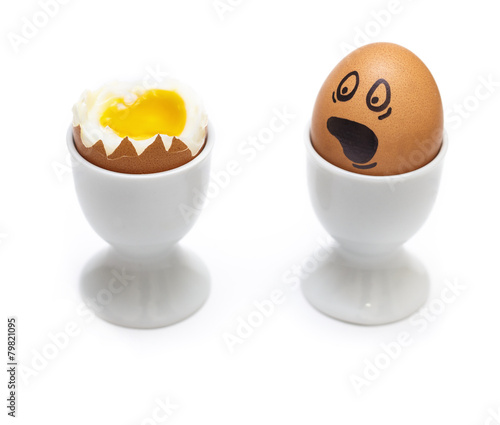 Soft boiled eggs with scared face isolated on white