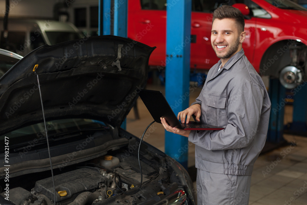 Auto mechanic checking the engine Auto mechanic checking the engine