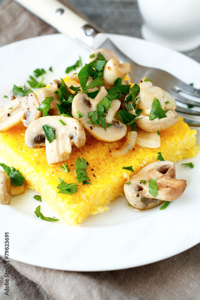 Italian polenta with champignons on a plate Italian polenta with champignons on a plate