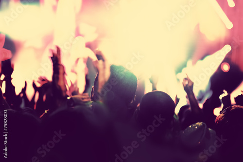 Concert, disco party. People with hands up in night club.
