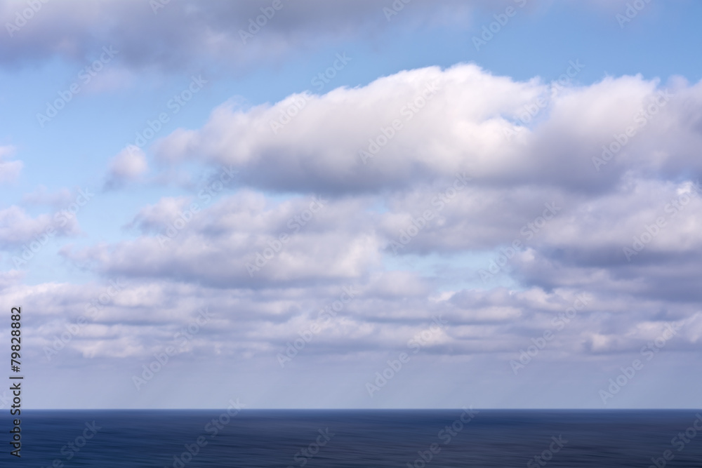 Cloudy blue sky over the blue sea Cloudy blue sky over the blue sea