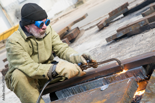 Welder cut metal sheet with propane oxygen gas blow torch burner