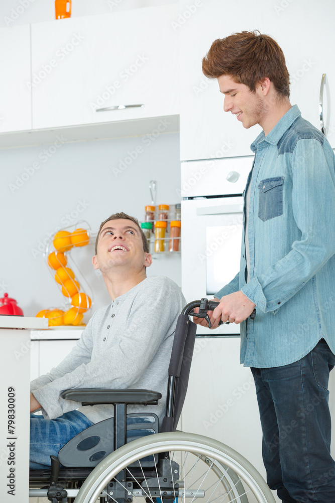 Teenager in wheelchair and his friend Teenager in wheelchair and his friend