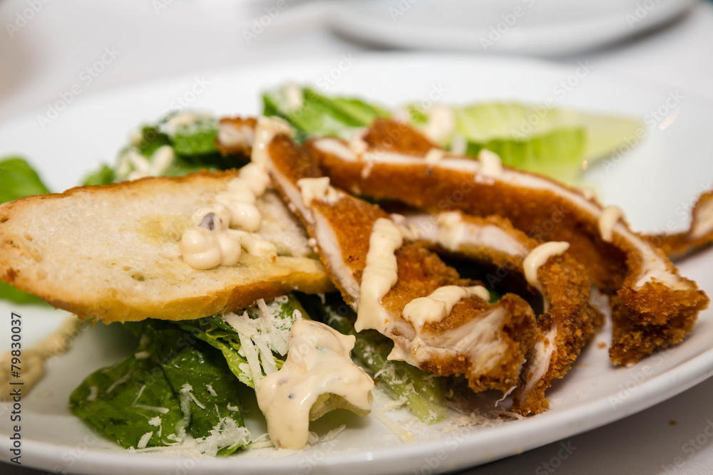 Breaded Chicken on Caesar Salad