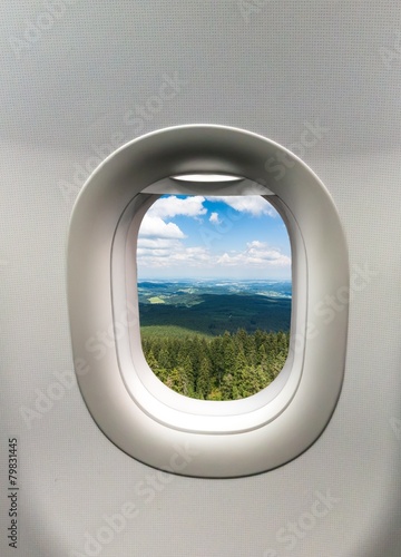 Looking out the window of a plane at the mountains