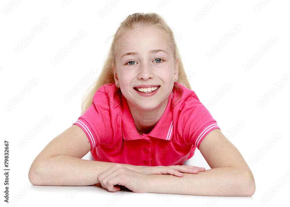 Positive blonde girl lying on the floor and looking directly at Positive blonde girl lying on the floor and looking directly at