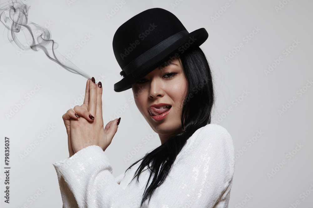 elegant woman with a hands like a gun and fog from it elegant woman with a hands like a gun and fog from it