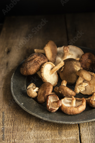 Fresh shiitake mushrooms in moody natural light setting with vin