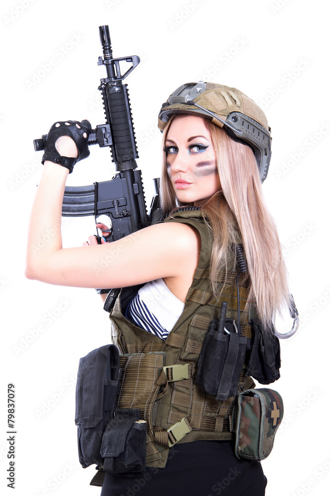 Woman in a military camouflage holding the assault rifle Woman in a military camouflage holding the assault rifle