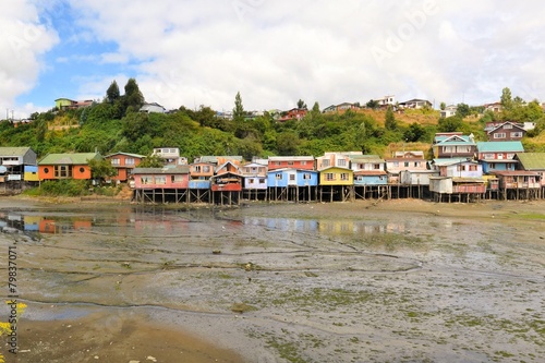 Houses raised on pillars over the water in Castro, Chiloe © flocu