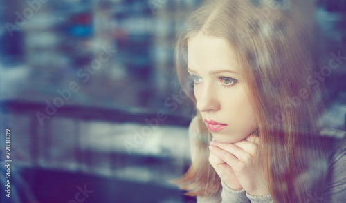 Fotografie, Obraz thoughtful sadness girl is sad at window