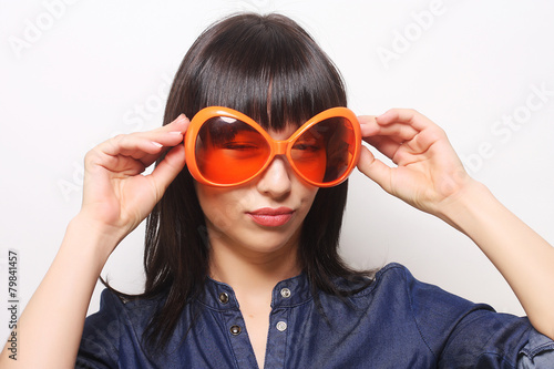 young happy woman with big orange sunglasses