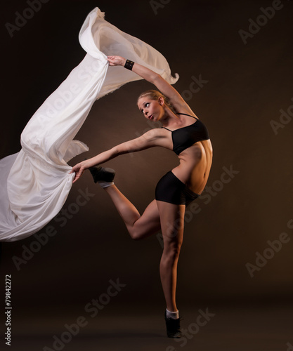 beautiful woman in motion holding fabric