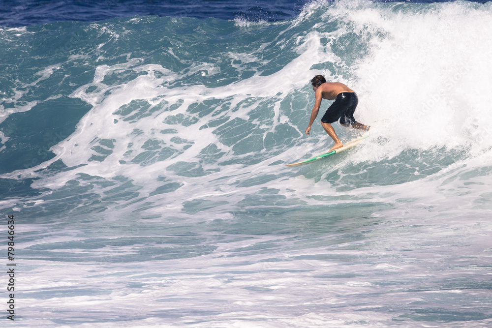 Extreme surfer riding giant ocean wave in Hawaii Extreme surfer riding giant ocean wave in Hawaii