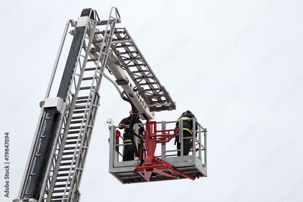 Firefighters at firetrack escape ladder during accident fighting