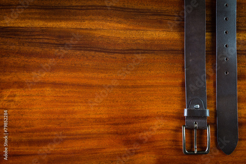 Mans leather belt on wooden table