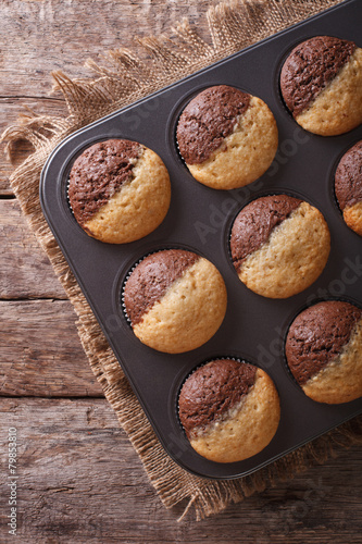 hot colorful cupcakes in a baking dish. Vertical top view