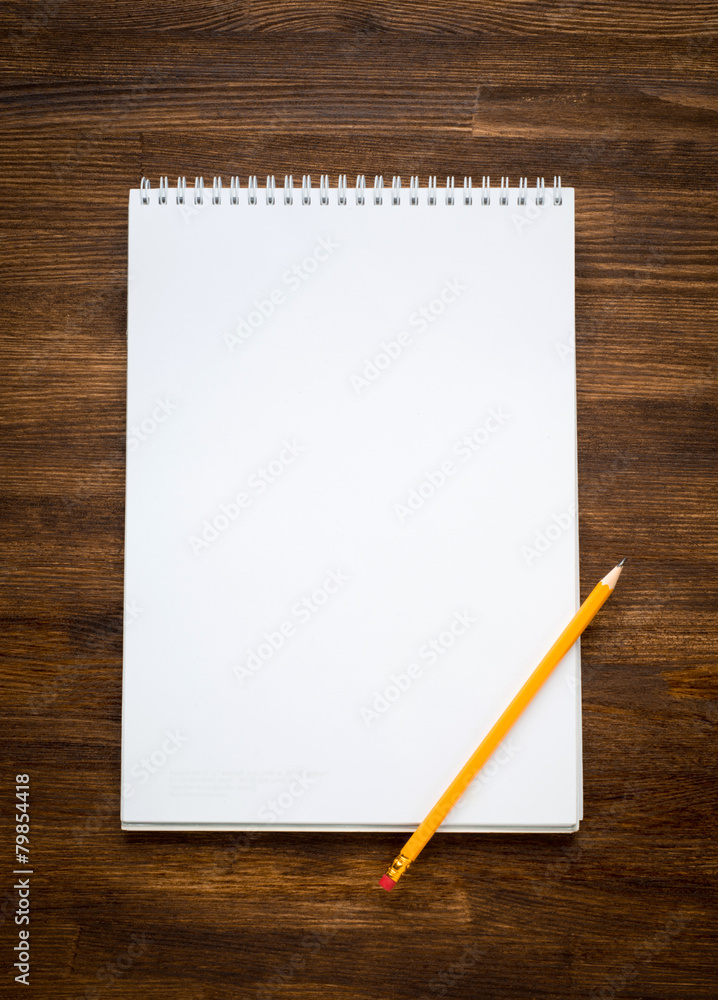 White blank papers in a copybook with pen on the wooden White blank papers in a copybook with pen on the wooden