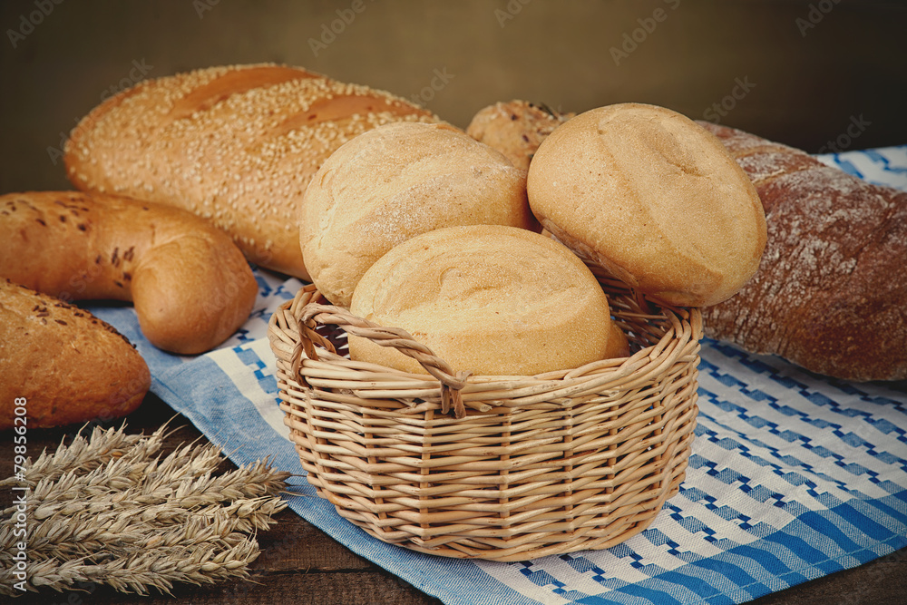 Wicker basket with bread products on the tablecloth