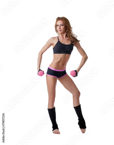 Sexy female bodybuilder exercising with dumbbells