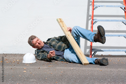 Injured construction worker fallen off ladder photo