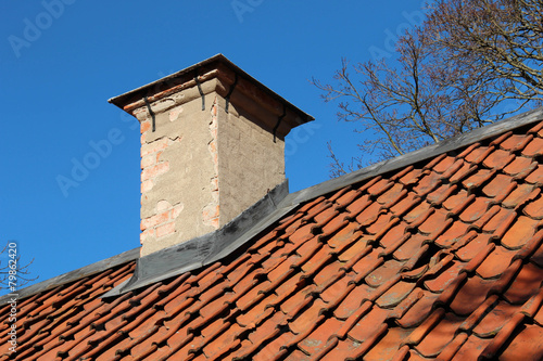 Chimney and rooftop on old cottage photo
