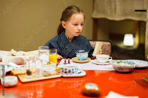 Little girl eating breakfast in Japan