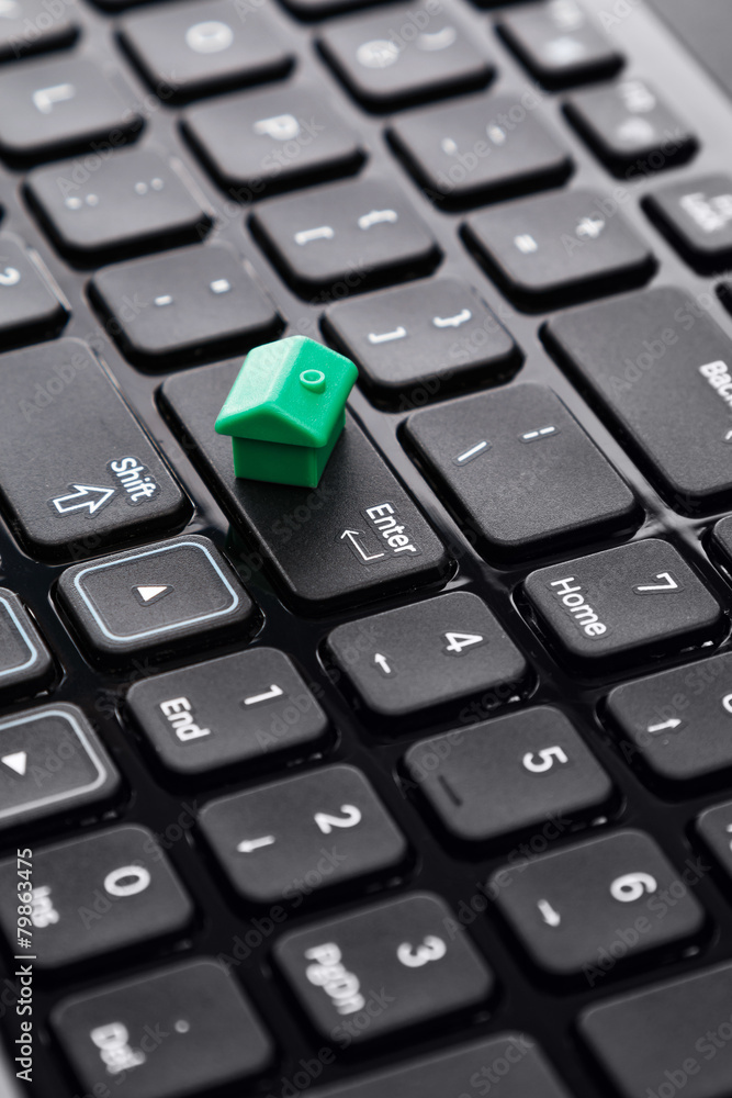 Small toy house over keyboard